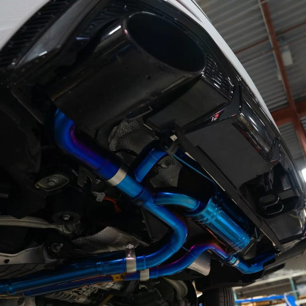 Boost Logic Titanium Exhaust System for Audi RSQ8 Installed on Car on Lift - Close Underside View of Rear Section