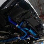 Boost Logic Titanium Exhaust System for Audi RSQ8 Installed on Car on Lift - Close Underside View of Rear Section