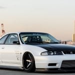 Garage Active Widebody Kit for R33 Nissan Skyline GT-R Installed on White R33 - Front-Side Vie of Car