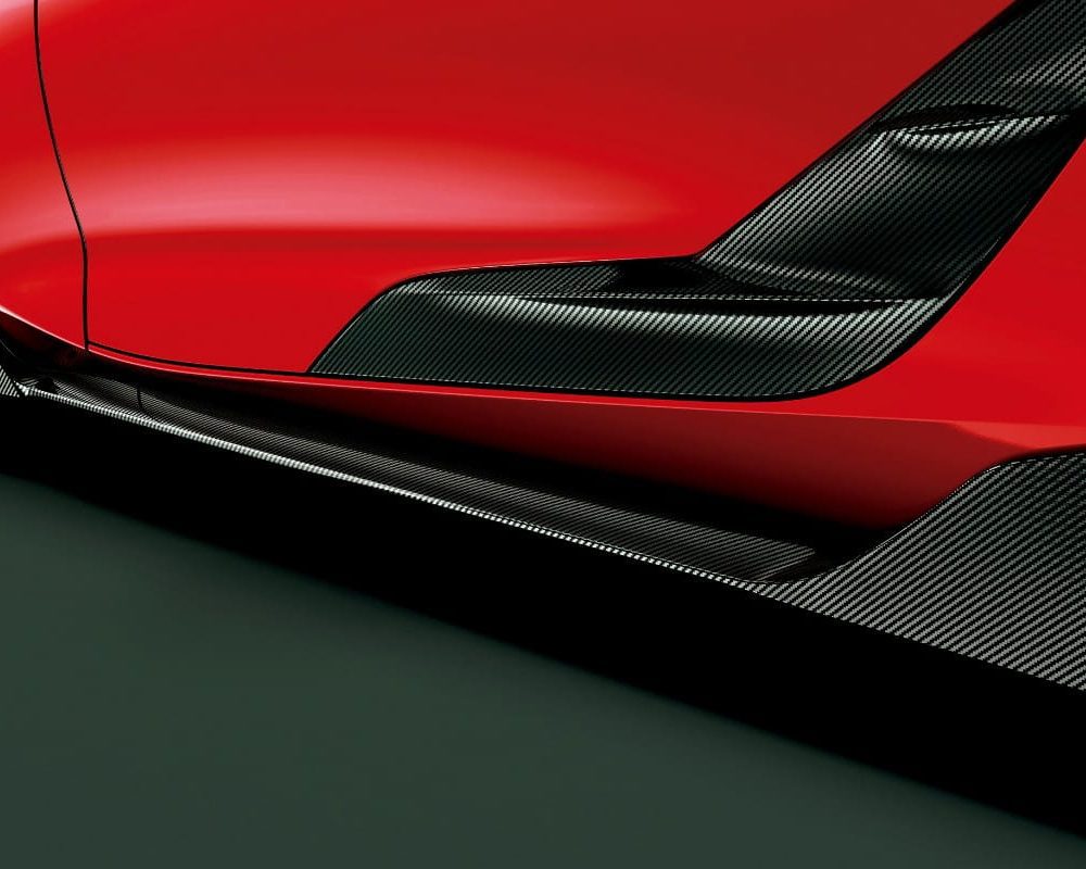 Toyota Gazoo Racing Carbon GR Side Skirts for A90 / A91 Toyota Supra Installed on Red Supra - Close Rear-side View of Side Skirts