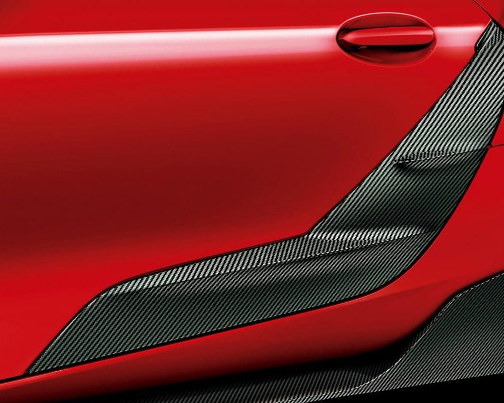 Toyota Gazoo Racing Carbon GR Side Door Garnishes for A90 / A91 Toyota Supra Installed on Red Supra - Close View of Garnishes