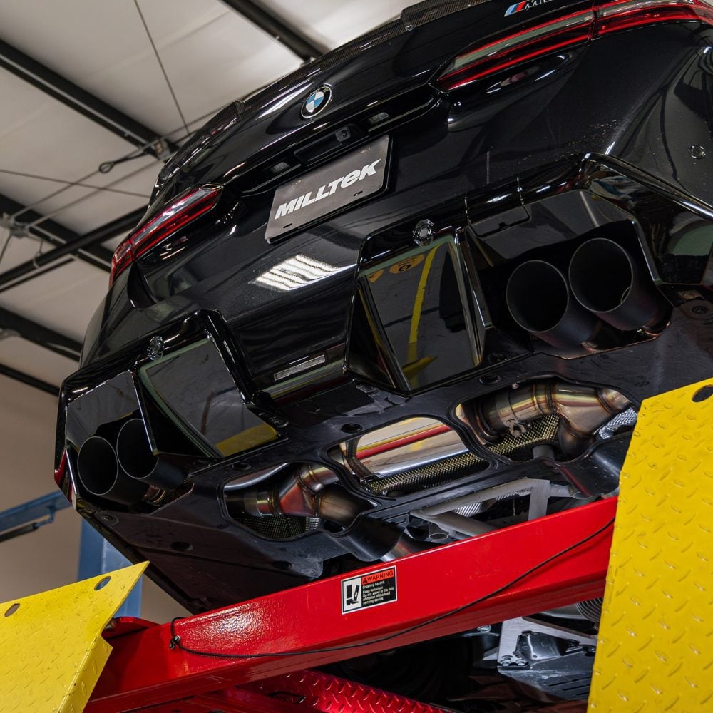 Milltek Valved Axle-Back Exhaust System for G90 / G99 BMW M5 Installed on Car on Lift - Close Rear Underside View of Axle-Back