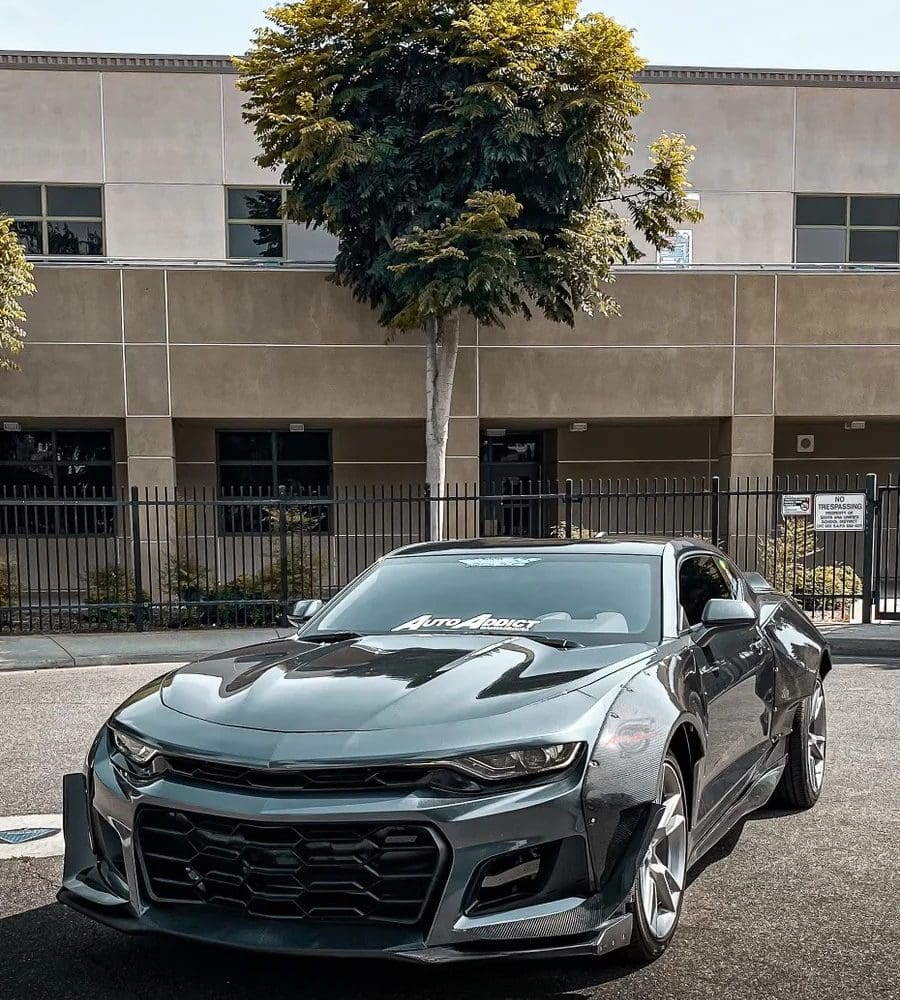 Auto Addict Carbon Wide Body Fender Kit w/ Front Bumper Canards for 6th Gen Chevrolet Camaro LT, RS, SS, and ZL1 Installed on Grey Camaro - Front Side View of Car