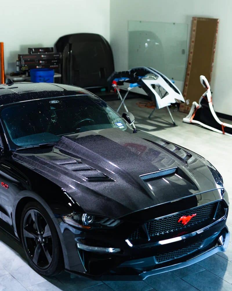 Auto Addict Carbon Terminator Aggressive Style Hood for S550 Ford Mustang EcoBoost, GT, Mach 1, and Shelby Models (facelift) Installed on Black S550 Mustang - Left Front View of Car