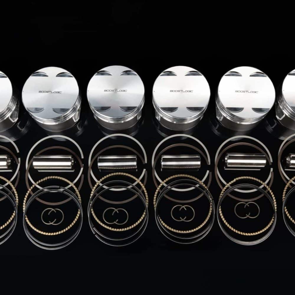 Boost Logic VR38 Pistons for R35 Nissan GT-R, set of six shown with rings and pins